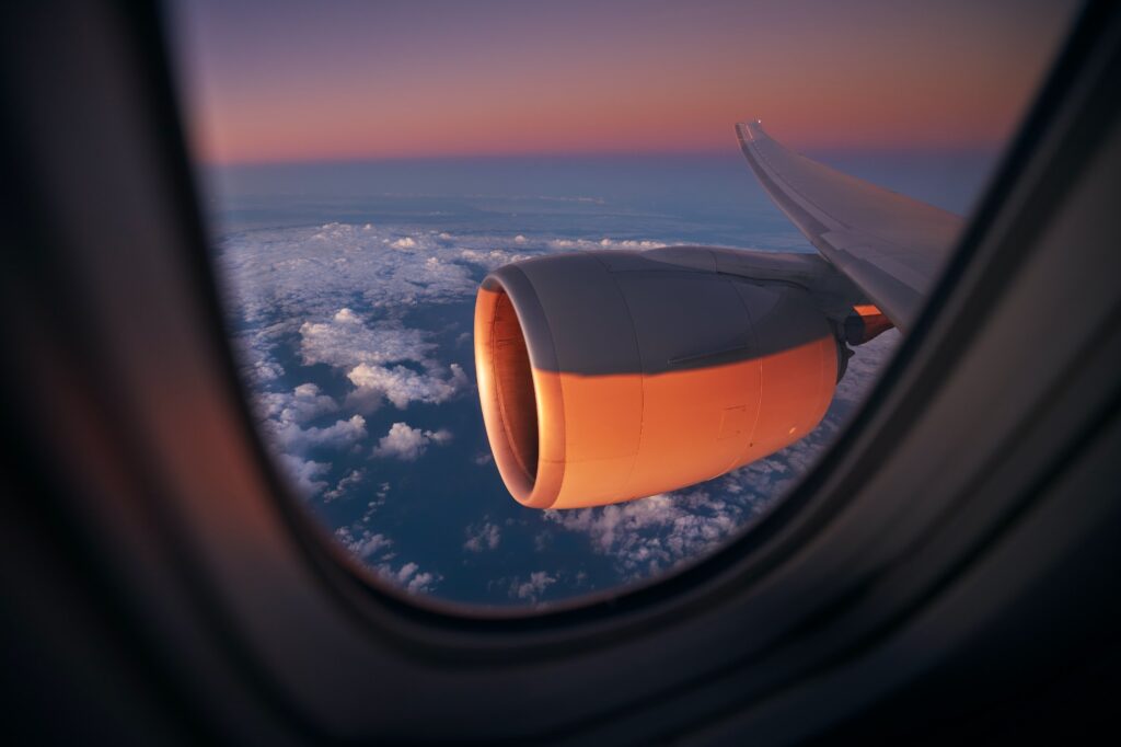 View from window of airplane during flight above ocean